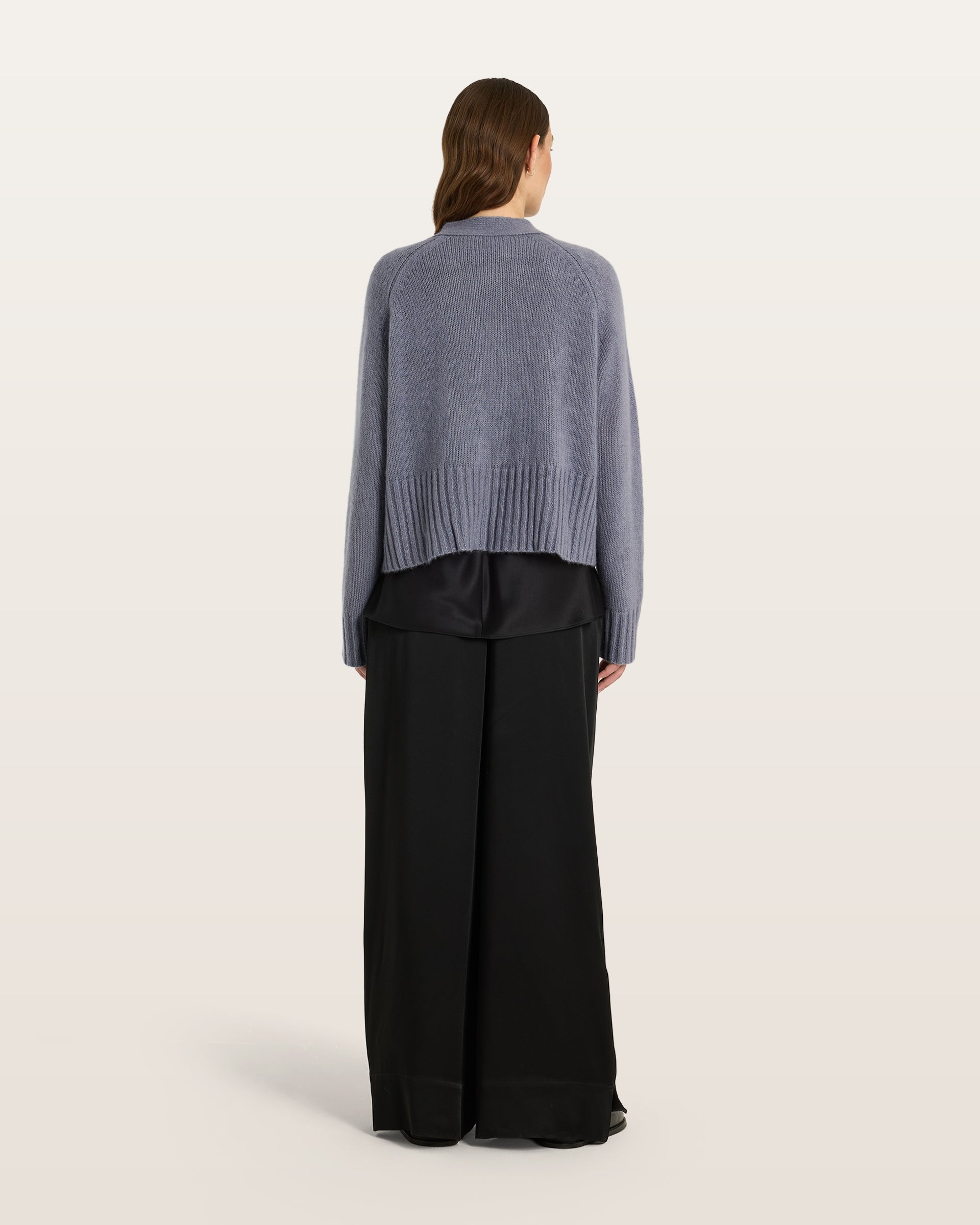 Damen Cardigan aus 75 % Kaschmir und 25 % Seide in Blue Mirage – glatt gestrickter Cardigan in mittelschwerer Qualität mit oversized Form in breiter, kurzer Silhouette. Das Modell verfügt über Raglanärmel, lange, relaxte Ärmel sowie Knöpfe aus waschbarem Leder. Saum und Ärmelbündchen sind in Rippstruktur gearbeitet und verleihen dem Cardigan einen modernen, lässigen Look.