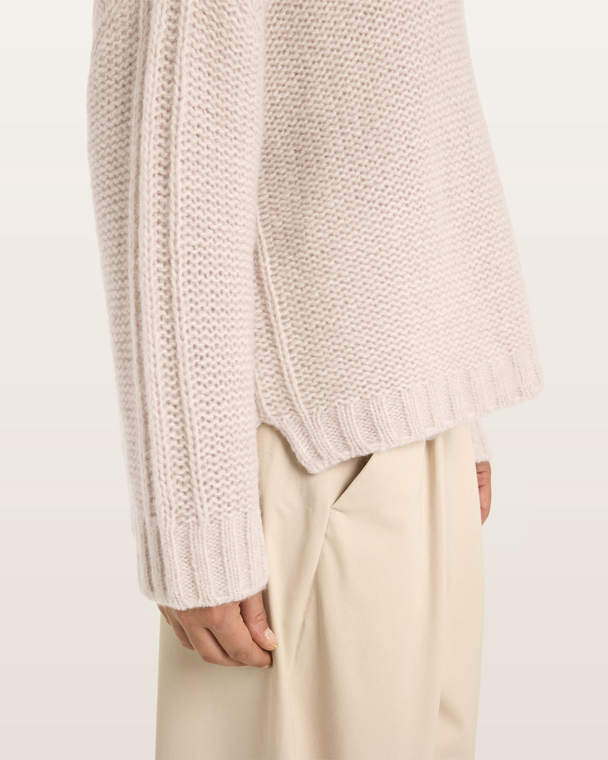 Damen Pullover aus 75 % Kaschmir und 25 % Seide in Wheat – links gestrickter Pullover in grober Strickqualität mit oversized Passform. Der Rollkragen in Rippstruktur, überschnittene Schultern und lange, relaxte Ärmel verleihen dem Modell eine lässige Silhouette. Rippstrukturen an Seitennähten, Schultern und Ärmeln setzen besondere Akzente, während das verlängerte Rückenteil und seitliche Schlitze den modernen Look abrunden.