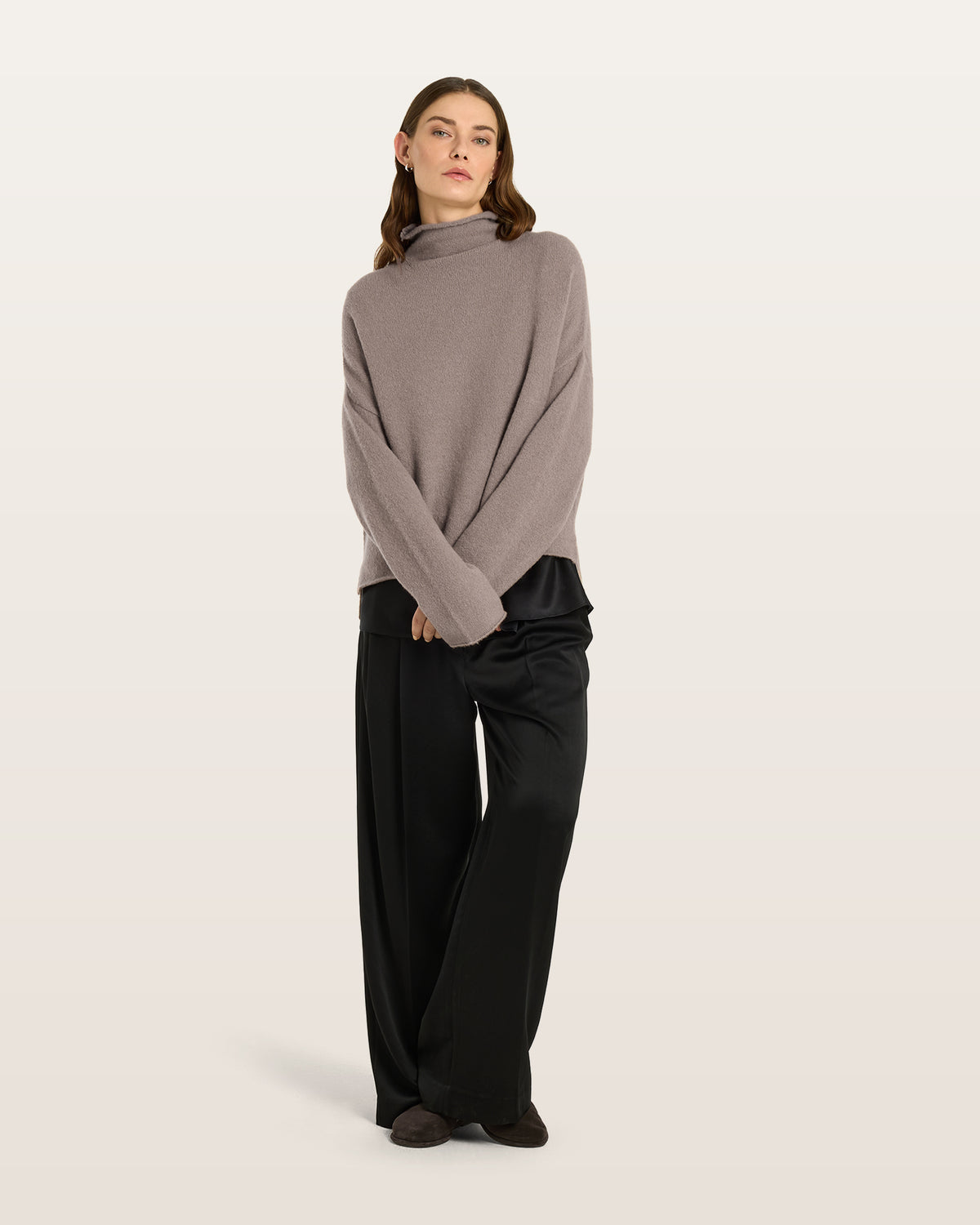 Damen Pullover aus 80 % Kaschmir, 18 % Polyamid und 2 % Elastan in Natural Twine – glatt gestrickter Pullover in mittelschwerer Qualität mit gefilzter, besonders elastischer Oberfläche und oversized Passform. Das Modell verfügt über einen Stehkragen, eine überschnittene Schulterform sowie lange, relaxte Ärmel. Das verlängerte Rückenteil mit Seitenschlitzen verleiht dem Pullover eine moderne, lässige Silhouette.