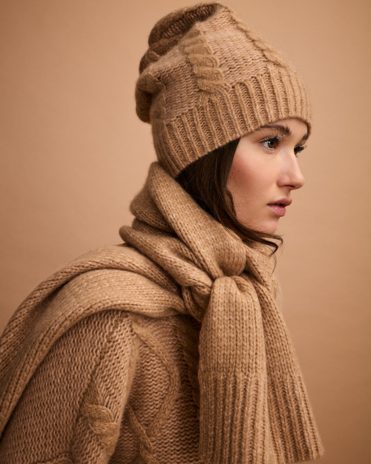 Damen Mütze aus 75 % Kaschmir und 25 % Seide in Sand Rose – Mütze aus Mouliné-Garn mit Zopfmuster und links gestrickter Struktur in grober Strickqualität. Der Umschlag in Rippstruktur verleiht dem Modell einen klassischen Look und sorgt für einen angenehmen Sitz.