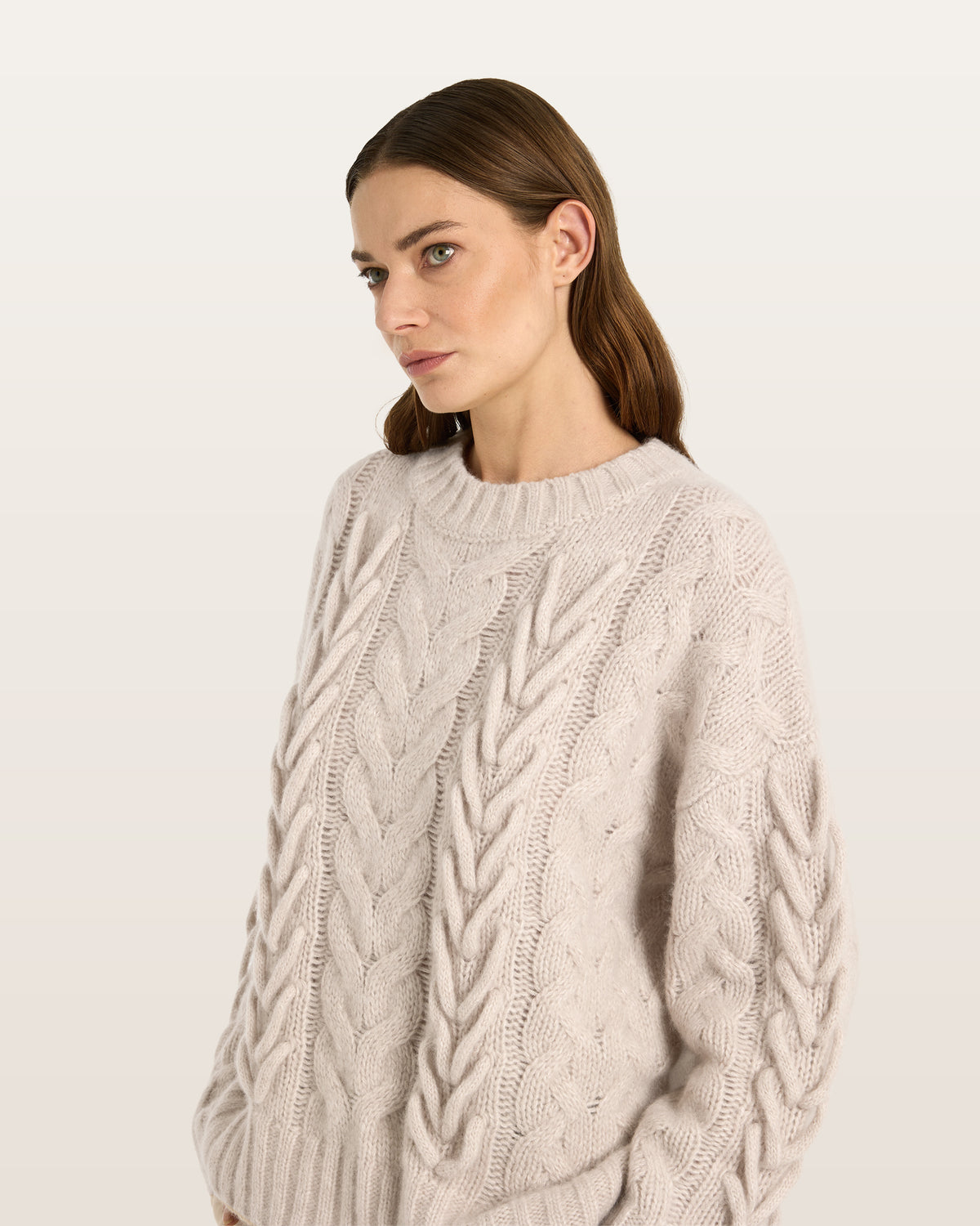 Damen Pullover aus 75 % Kaschmir und 25 % Seide in Wheat – Pullover mit Zopfstrickmuster und zusätzlich applizierten 3D-Zöpfen in grober Strickqualität mit relaxter Passform, Rundhalsausschnitt mit Kragen in Rippstruktur, überschnittener Schulter sowie langen, relaxten Ärmeln. Ärmelbündchen und Saum sind in Rippstruktur gearbeitet und unterstreichen den markanten, handwerklichen Charakter des Designs.
