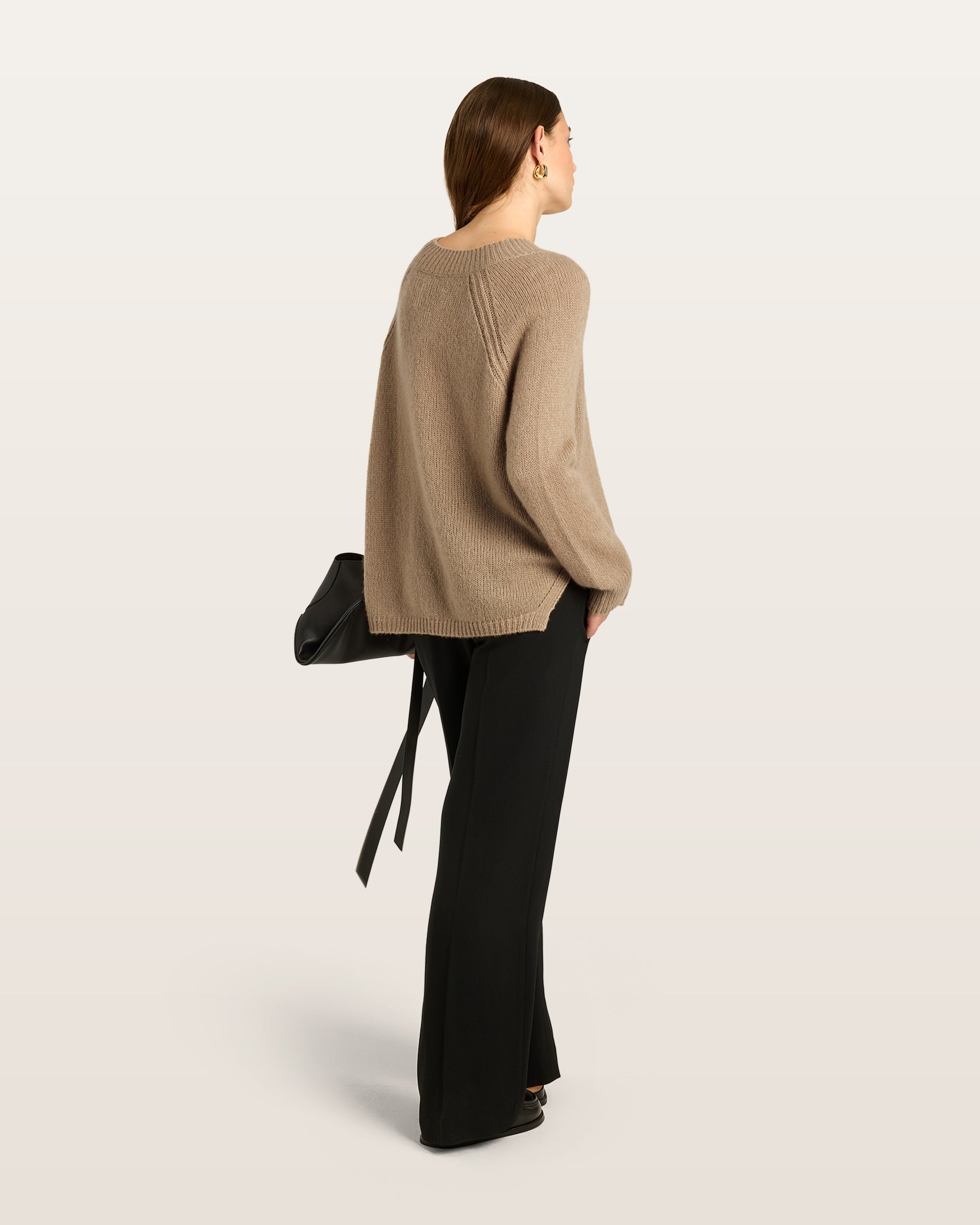 Damen Pullover aus 75 % Kaschmir und 25 % Seide in Warm Sand  – glatt und locker gestrickter Pullover in mittelschwerer Qualität mit locker fallender Passform, Rundhalsausschnitt mit breitem Kragen in Rippstruktur, Raglanärmeln sowie langen, relaxten Ärmeln. Saum und Ärmelbündchen sind in Rippstruktur gearbeitet. Schlitze an den Seiten verleihen dem Modell eine moderne, lässige Silhouette.

