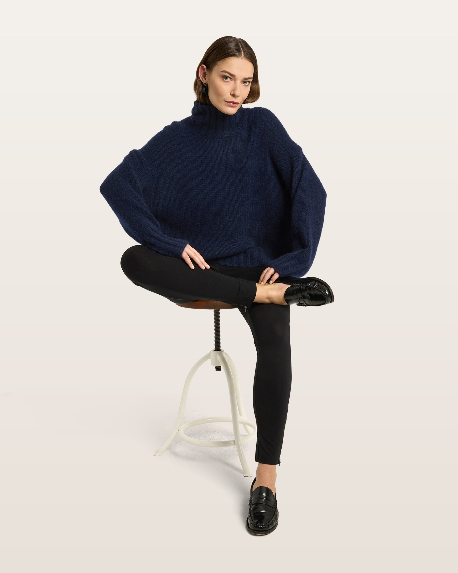 Damen Pullover aus 75 % Kaschmir und 25 % Seide in French Navy – glatt gestrickter Pullover in grober Strickqualität mit oversized Passform in langer, weiter Silhouette, hohem Stehkragen in Rippstruktur, überschnittener Schulter mit nach hinten verlegter Schulternaht sowie langen, weiten Ärmeln. Ärmelbündchen und Saum sind in Rippstruktur gearbeitet und verleihen dem Modell einen modernen, markanten Look.
