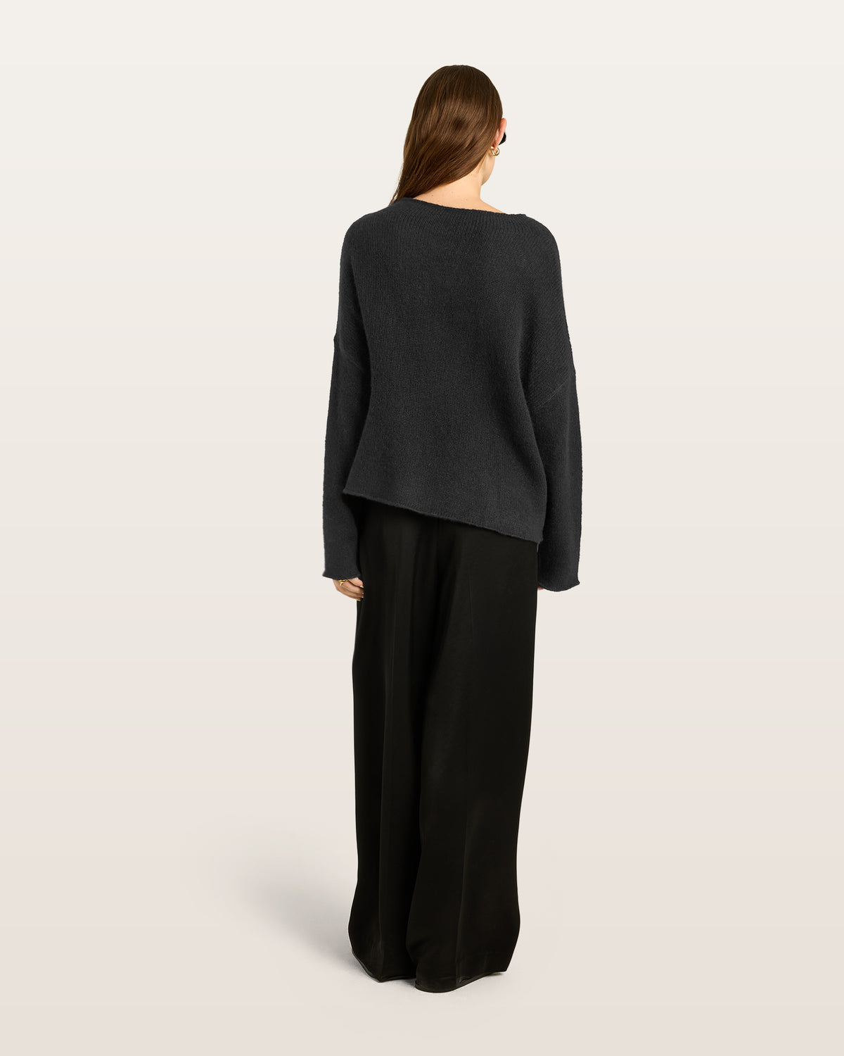 Damen Pullover aus 75 % Kaschmir und 25 % Seide in Black – glatt und locker gestrickter Pullover in mittelschwerer Qualität mit oversized Passform, breiter und kurzer Silhouette sowie cleanem Rundhalsausschnitt. Überschnittene Schultern und lange, relaxte Ärmel unterstreichen den modernen Look, während Ärmelbündchen und Saum mit speziellem Finish für einen besonderen Akzent sorgen.