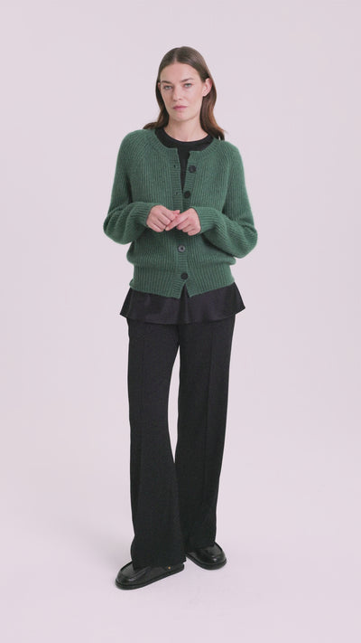 Damen Cardigan aus 75 % Kaschmir und 25 % Seide in Emerald – Cardigan im Patent-Strickmuster in mittelschwerer Qualität mit relaxter Passform, Rundhalsausschnitt mit Kragen in Rippstruktur, Raglanärmeln sowie langen, schmalen Ärmeln. Ärmelbündchen und Saum sind in Rippstruktur gearbeitet. Knöpfe aus waschbarem Leder verleihen dem Modell einen hochwertigen, stilvollen Akzent.
